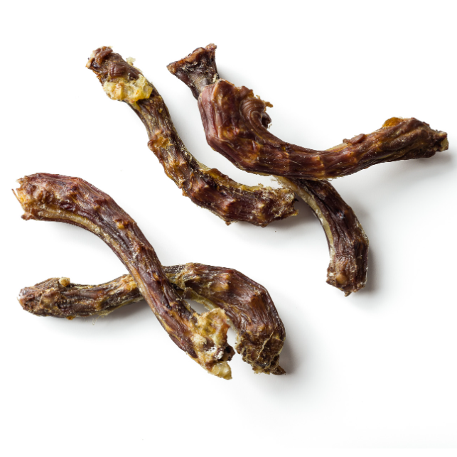 Three brown dog treats on a white background