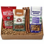 Assorted dog treats in a box with visible packaging of different brands.
