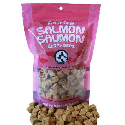 Pink package of freeze-dried salmon treats with visible treats on a white background