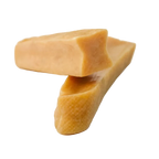 Two pieces of yellow cheese on a white background