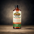 A bottle of Waggy Butts Gut & Yeast Support Oil for dogs, displayed on a wooden surface against a dark, smoky background.